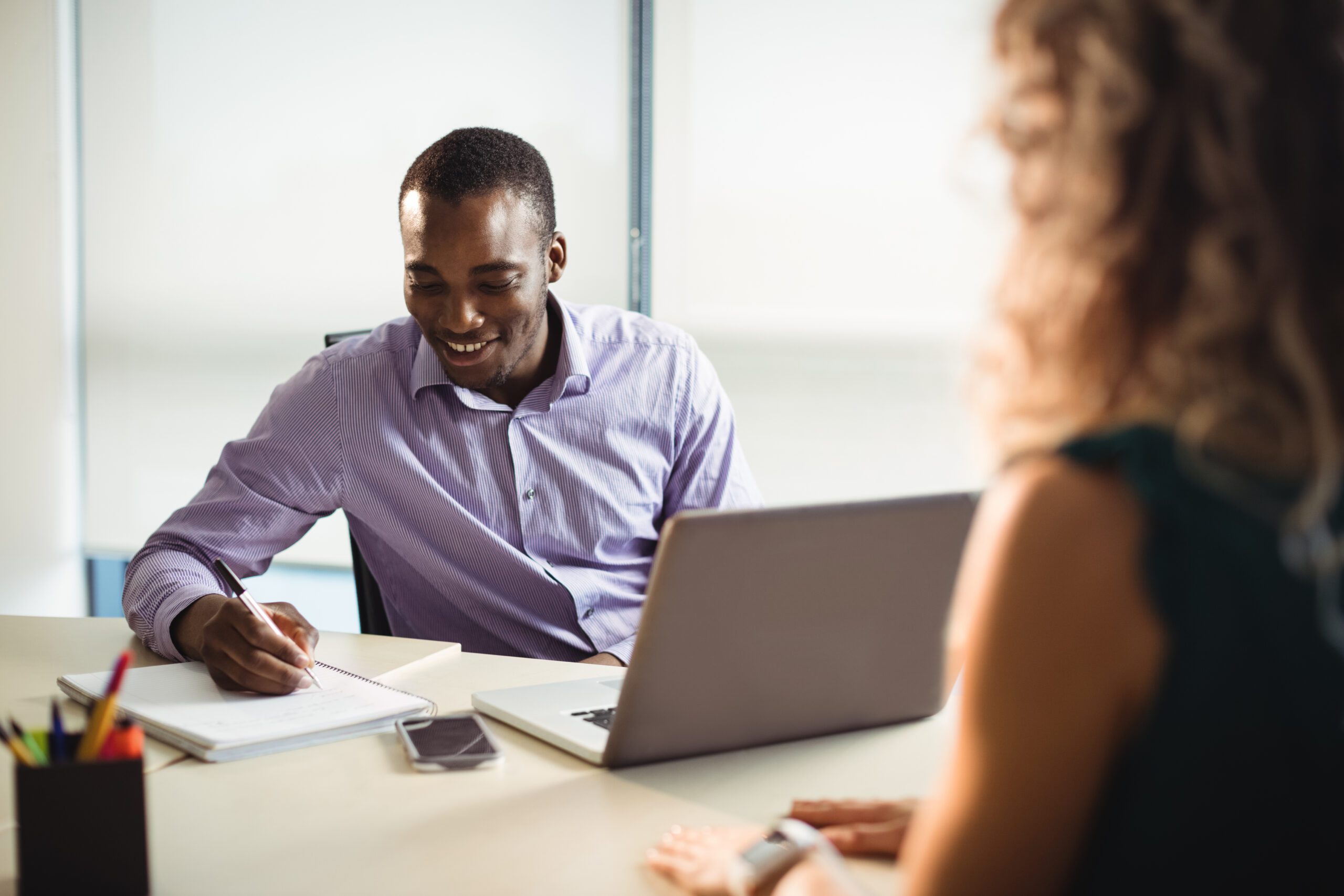 Business executives interacting with each other in office